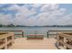 Community dock over serene waters with scenic views and benches for relaxation at 5575 Gulf Blvd # 329, St Pete Beach, FL 33706