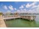 View from the community dock showing benches and views of the water and other condo buildings at 5575 Gulf Blvd # 329, St Pete Beach, FL 33706