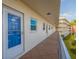 Hallway view with unit door, leading to a private residence in the building's community at 5575 Gulf Blvd # 329, St Pete Beach, FL 33706