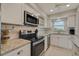 Modern kitchen with stainless steel appliances, granite countertops and plenty of cabinets at 5575 Gulf Blvd # 329, St Pete Beach, FL 33706