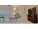 Comfortable living room with a sofa, armchair, TV, and floral artwork, creating a relaxing space at 5575 Gulf Blvd # 329, St Pete Beach, FL 33706