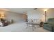 Spacious living room with carpet flooring and neutral walls and a ceiling fan at 5575 Gulf Blvd # 329, St Pete Beach, FL 33706