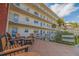 Charming outdoor patio with comfortable seating and views of the surrounding landscaping at 5575 Gulf Blvd # 329, St Pete Beach, FL 33706