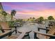 Outdoor patio area, featuring seating, a table, and a beautiful view of the surrounding greenery at 5575 Gulf Blvd # 329, St Pete Beach, FL 33706