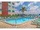 Community pool with ample seating and partial water view at 5575 Gulf Blvd # 329, St Pete Beach, FL 33706
