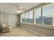 Bright sunroom featuring multiple windows, neutral tile floors, and a ceiling fan at 5575 Gulf Blvd # 329, St Pete Beach, FL 33706