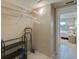 Practical walk-in closet with shelving and ample storage space and access to the bedroom at 5575 Gulf Blvd # 329, St Pete Beach, FL 33706