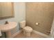 Powder room boasts designer wall paper, pedestal sink, and neutral flooring at 6417 Blue Sail Ln, Apollo Beach, FL 33572