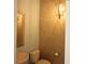 This half bath includes elegant lighting and beautiful wallpaper at 6417 Blue Sail Ln, Apollo Beach, FL 33572