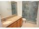 Bathroom features a granite vanity and glass enclosed shower at 6417 Blue Sail Ln, Apollo Beach, FL 33572