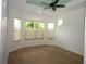 Inviting bedroom with multiple windows and a fan creating a comfortable ambiance at 6417 Blue Sail Ln, Apollo Beach, FL 33572