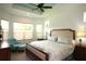 Serene primary bedroom with a ceiling fan, large windows, and plenty of natural light at 6417 Blue Sail Ln, Apollo Beach, FL 33572