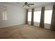 Spacious bedroom with carpet, ceiling fan, and multiple windows for natural light at 6417 Blue Sail Ln, Apollo Beach, FL 33572
