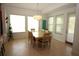 Bright dining room with natural light, a stylish chandelier, and a dining table with six chairs at 6417 Blue Sail Ln, Apollo Beach, FL 33572