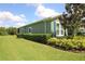 Well-maintained exterior featuring neat landscaping, healthy hedges, and an expansive green lawn at 6417 Blue Sail Ln, Apollo Beach, FL 33572