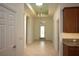 Bright foyer showcases neutral tile flooring, a decorative ceiling, and elegant chandelier lighting at 6417 Blue Sail Ln, Apollo Beach, FL 33572
