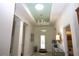 Bright foyer featuring high ceilings, elegant chandelier, and decorative details at 6417 Blue Sail Ln, Apollo Beach, FL 33572