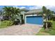 Charming home featuring manicured landscaping and a brick driveway, leading to an attached garage at 6417 Blue Sail Ln, Apollo Beach, FL 33572
