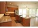 Open kitchen featuring stainless appliances, granite countertops, and a large island with pendant lighting at 6417 Blue Sail Ln, Apollo Beach, FL 33572