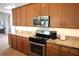 Well-equipped kitchen with granite countertops and stainless steel appliances at 6417 Blue Sail Ln, Apollo Beach, FL 33572