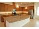 Spacious kitchen with stainless steel appliances, granite countertops, and a large center island at 6417 Blue Sail Ln, Apollo Beach, FL 33572