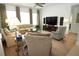 Cozy living room with plush seating, large windows, and a ceiling fan at 6417 Blue Sail Ln, Apollo Beach, FL 33572
