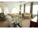 Comfortable living room with plush seating, large windows and a ceiling fan at 6417 Blue Sail Ln, Apollo Beach, FL 33572