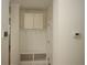 Mudroom with white cabinets, hooks, and a bench for storage and convenience at 6417 Blue Sail Ln, Apollo Beach, FL 33572