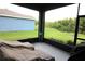 Relaxing screened-in porch featuring two lounge chairs and scenic backyard views at 6417 Blue Sail Ln, Apollo Beach, FL 33572