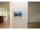 Wall panel with a display showing a scenic lake view enhancing interior aesthetics at 6417 Blue Sail Ln, Apollo Beach, FL 33572