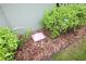The yard includes a discreetly placed irrigation control point amidst mulch, landscaping and lush greenery at 6417 Blue Sail Ln, Apollo Beach, FL 33572
