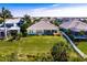 A scenic aerial view of the backyard, lush landscaping, and a charming white fence line at 716 Manns Harbor Dr, Apollo Beach, FL 33572