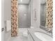 Well-appointed bathroom features a shower with tile surround, a stylish vanity, and soft lighting creating a spa-like retreat at 716 Manns Harbor Dr, Apollo Beach, FL 33572