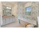 Elegant bathroom with floral wallpaper, soaking tub, granite vanity, and ample lighting at 716 Manns Harbor Dr, Apollo Beach, FL 33572