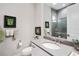 Elegant bathroom featuring a modern vanity, a spacious shower, and tasteful decor, creating a luxurious ambiance at 716 Manns Harbor Dr, Apollo Beach, FL 33572