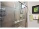 Modern bathroom featuring a sleek glass-enclosed shower with gray subway tiles, offering a spa-like experience at 716 Manns Harbor Dr, Apollo Beach, FL 33572