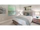 Sunlit bedroom features a comfortable bed, stylish side tables, and serene artwork, creating a relaxing retreat at 716 Manns Harbor Dr, Apollo Beach, FL 33572