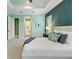 Relaxing bedroom with blue walls, tray ceiling, plush bed, and an en-suite bathroom at 716 Manns Harbor Dr, Apollo Beach, FL 33572