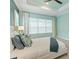 Comfortable bedroom with accent pillows, ample natural light, and neutral tones at 716 Manns Harbor Dr, Apollo Beach, FL 33572