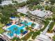 Aerial shot of the community pool area, featuring multiple pools, a play area, and ample lounge seating at 716 Manns Harbor Dr, Apollo Beach, FL 33572
