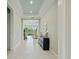 Inviting entryway with a textured wall, tiled floors, recessed lighting, and console table leading into the living space at 716 Manns Harbor Dr, Apollo Beach, FL 33572