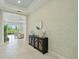 Inviting foyer with decorative console table and mirror, tiled floors and living room views at 716 Manns Harbor Dr, Apollo Beach, FL 33572