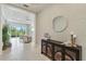 Inviting foyer with decorative console table and mirror, tiled floors and living room views at 716 Manns Harbor Dr, Apollo Beach, FL 33572