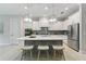 Stylish kitchen with white cabinetry, gray island, stainless steel appliances, and modern pendant lighting at 716 Manns Harbor Dr, Apollo Beach, FL 33572