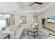 Open-concept living space featuring tile flooring, comfortable seating, and a view of the adjacent office at 716 Manns Harbor Dr, Apollo Beach, FL 33572