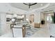 Bright and open living room featuring tile floors, recessed lighting, ceiling fan, and adjacent kitchen with island at 716 Manns Harbor Dr, Apollo Beach, FL 33572