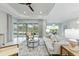 Open living area with tile flooring, comfortable seating, and sliders providing natural light and views of the outdoors at 716 Manns Harbor Dr, Apollo Beach, FL 33572