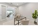 Bright home office featuring modern desk, chair, and plant with views to the dining and living area at 716 Manns Harbor Dr, Apollo Beach, FL 33572