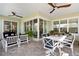 Covered patio with brick flooring, ceiling fans, and outdoor seating with sliding doors leading inside at 716 Manns Harbor Dr, Apollo Beach, FL 33572