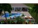 A rendering of a backyard pool with lounge chairs, a patio area and tropical foliage at 716 Manns Harbor Dr, Apollo Beach, FL 33572